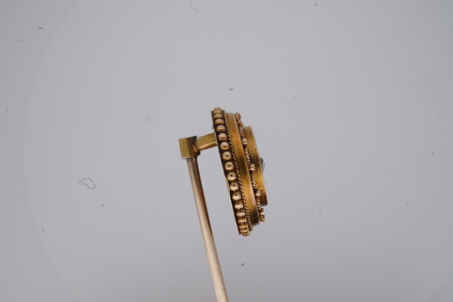 A Victorian gold and diamond stick pin, late 19th century, of circular outline with rope twist and grainti decoration, centring on a rose-cut diamond, length 7cm, gross weight 3 grams